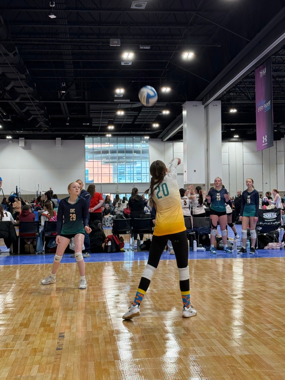 Volleyball player in mid-air about to spike the ball